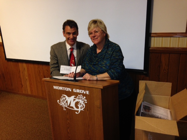 Mayor Dan DiMaria presents a check in the amount of $3,000, donated by the Morton Grove American Legion Post 134, to Morton Grove Days President Georgianne Brunner. Mayor Dan DiMaria presents a check in the amount of $3,000, donated by the Morton Grove American Legion Post 134, to Morton Grove Days President Georgianne Brunner.