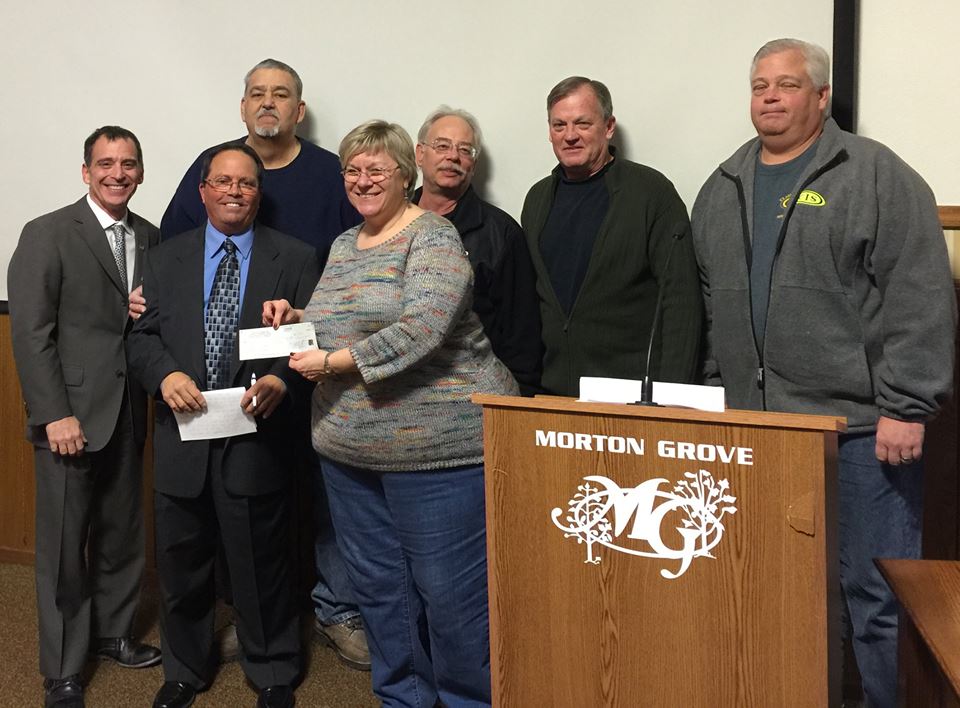 Morton Grove Moose Lodge representatives present a $3,000 check to Morton Grove Days President Georgianne Brunner. Morton Grove Moose Lodge representatives present a $3,000 check to Morton Grove Days President Georgianne Brunner.